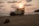 A rugged Jeep parked on a sandy beach at sunset.