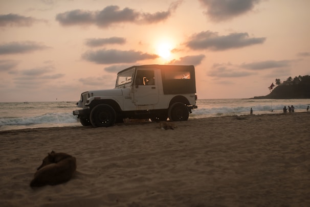 A jeep crossing the sandy sea of sand at Mount Bromo at dawn.