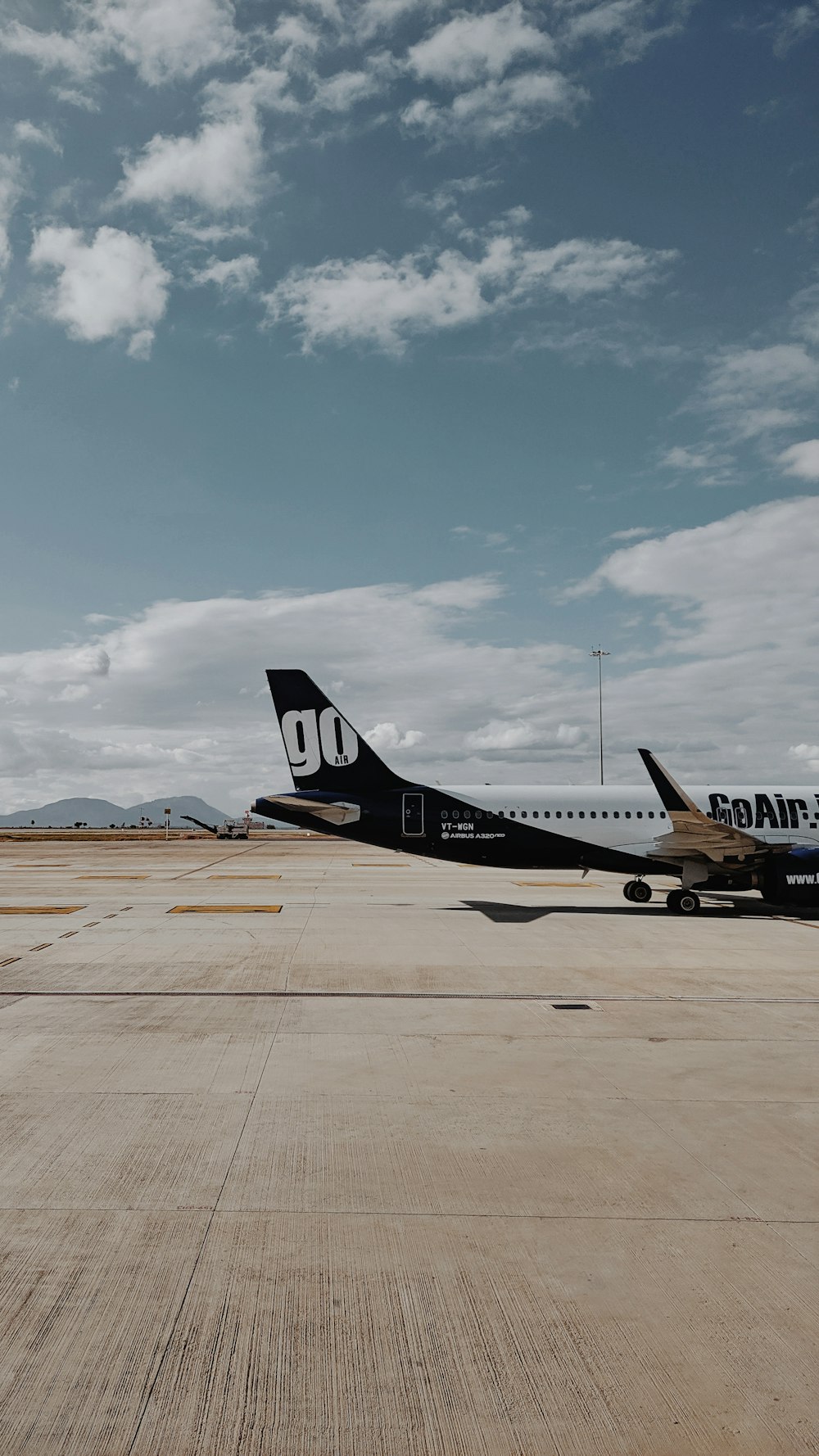 blue and white passenger plane on airport during daytime