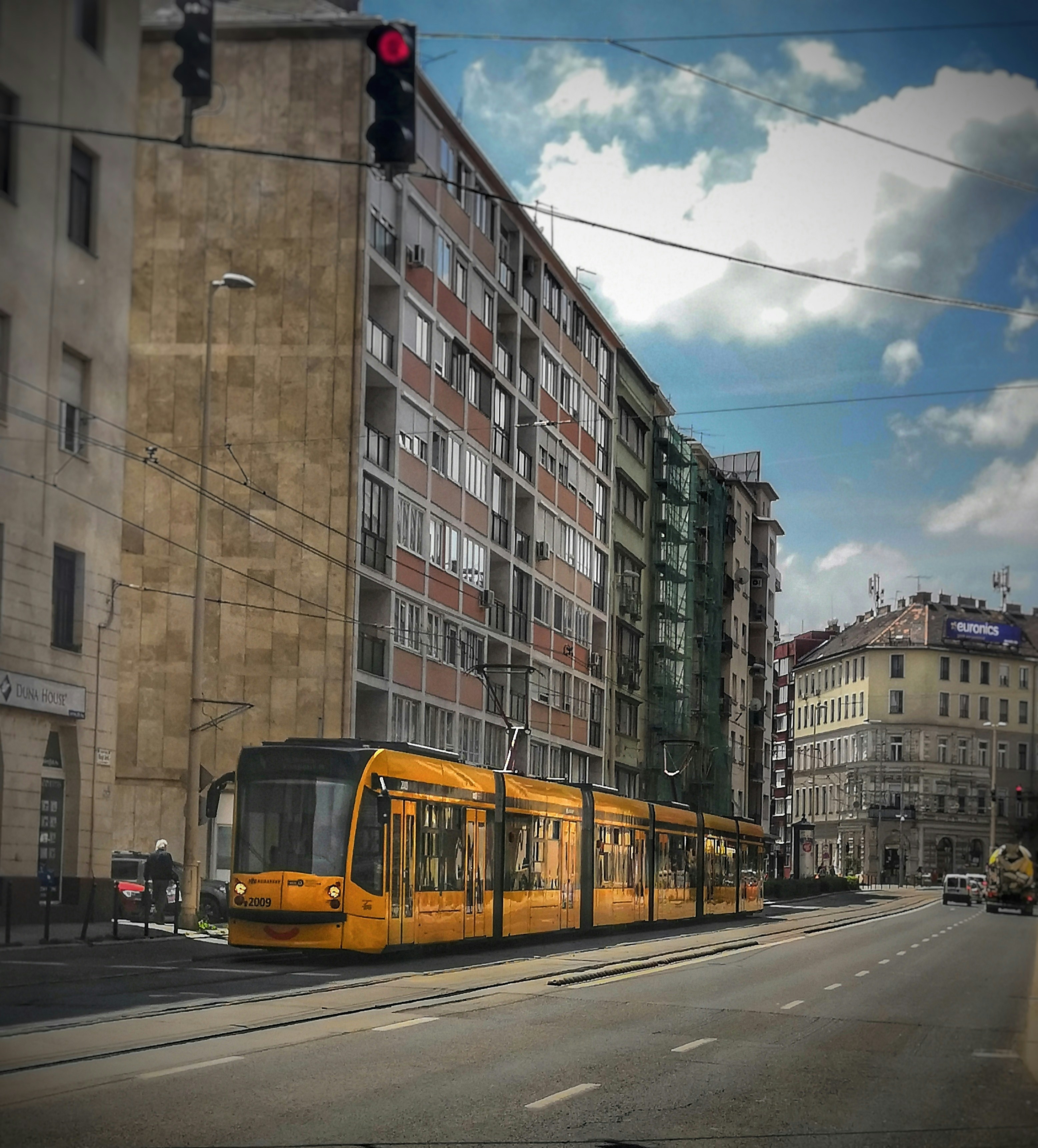 yellow and white tram on road near building during daytime