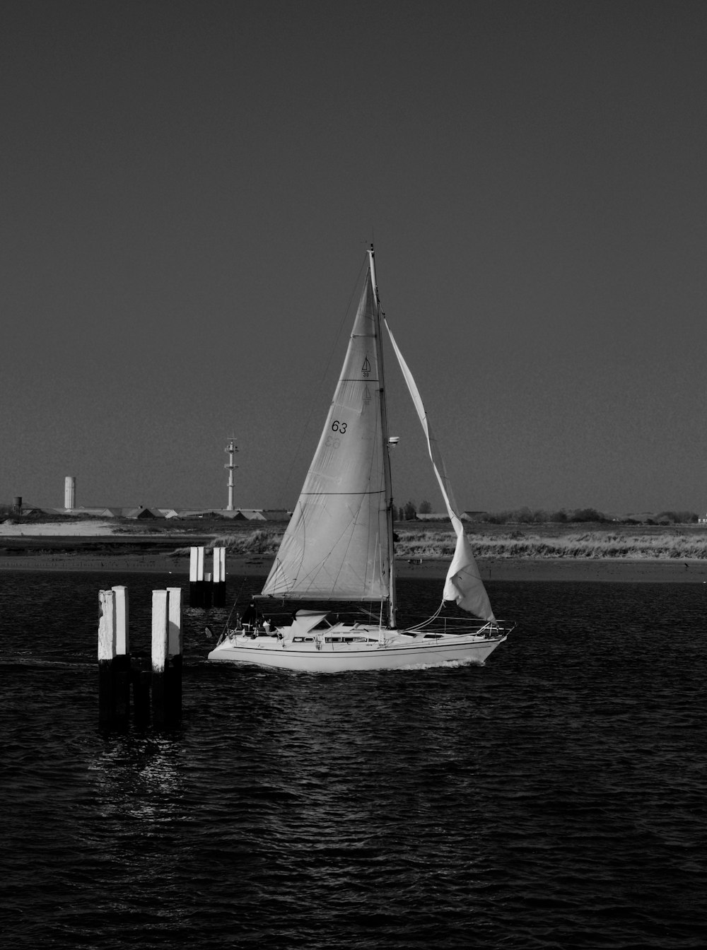 grayscale photo of sailboat on sea