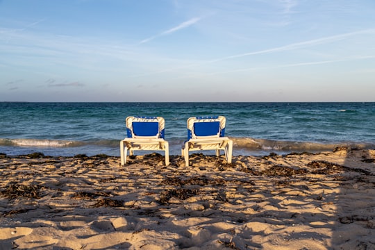 white wooden armchair on beach shore during daytime in Varadero Cuba