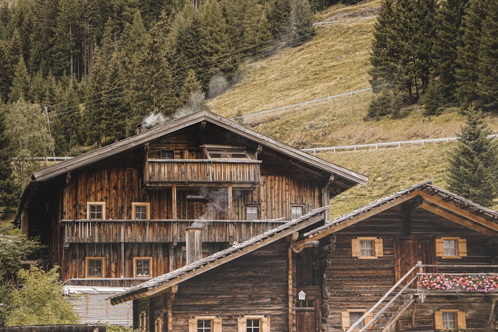 brown wooden house near green trees during daytime