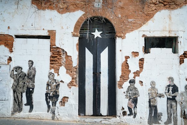 Black and white door on brown brick wall — San Juan, Puerto Rico
