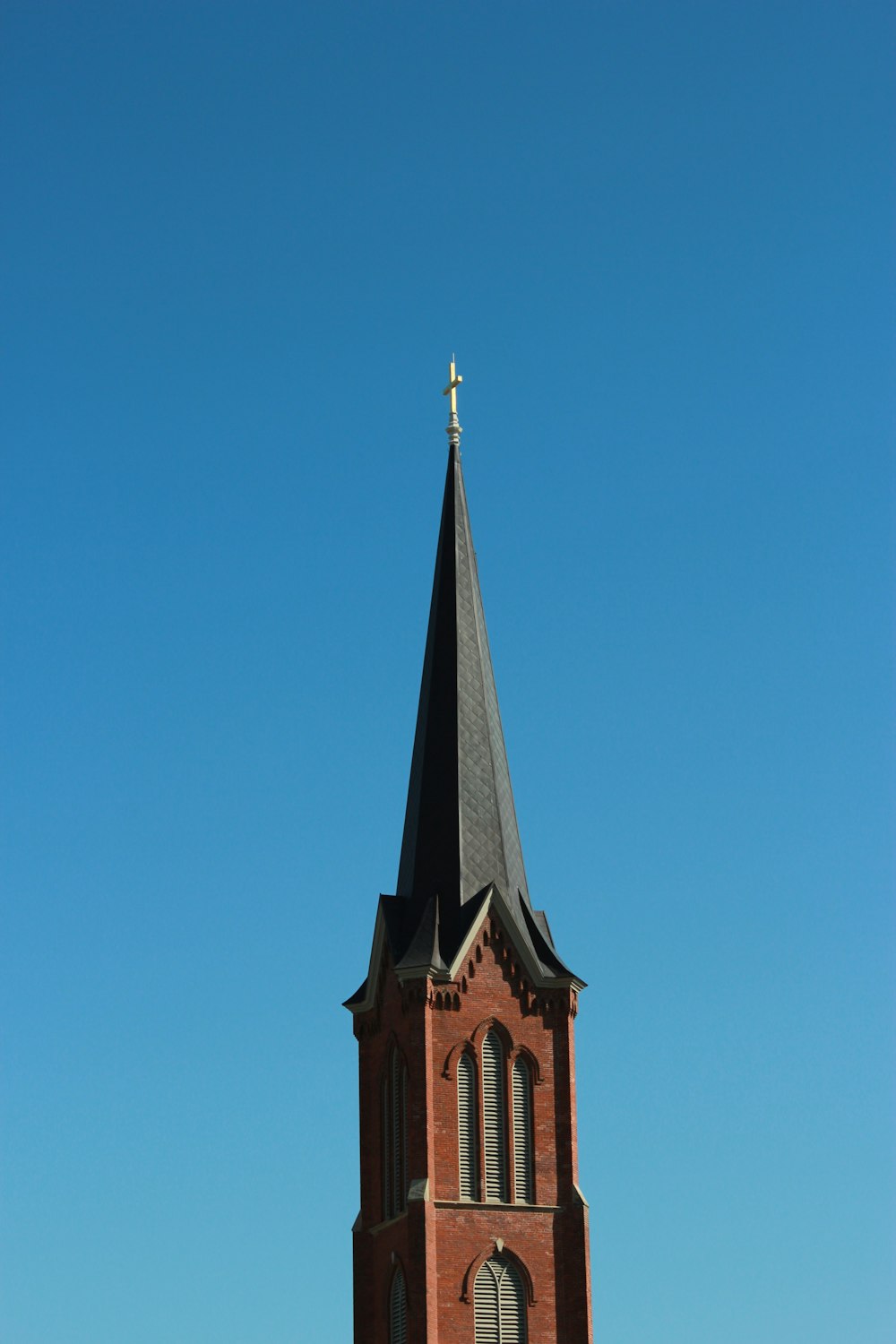 brown and black concrete building under blue sky during daytime