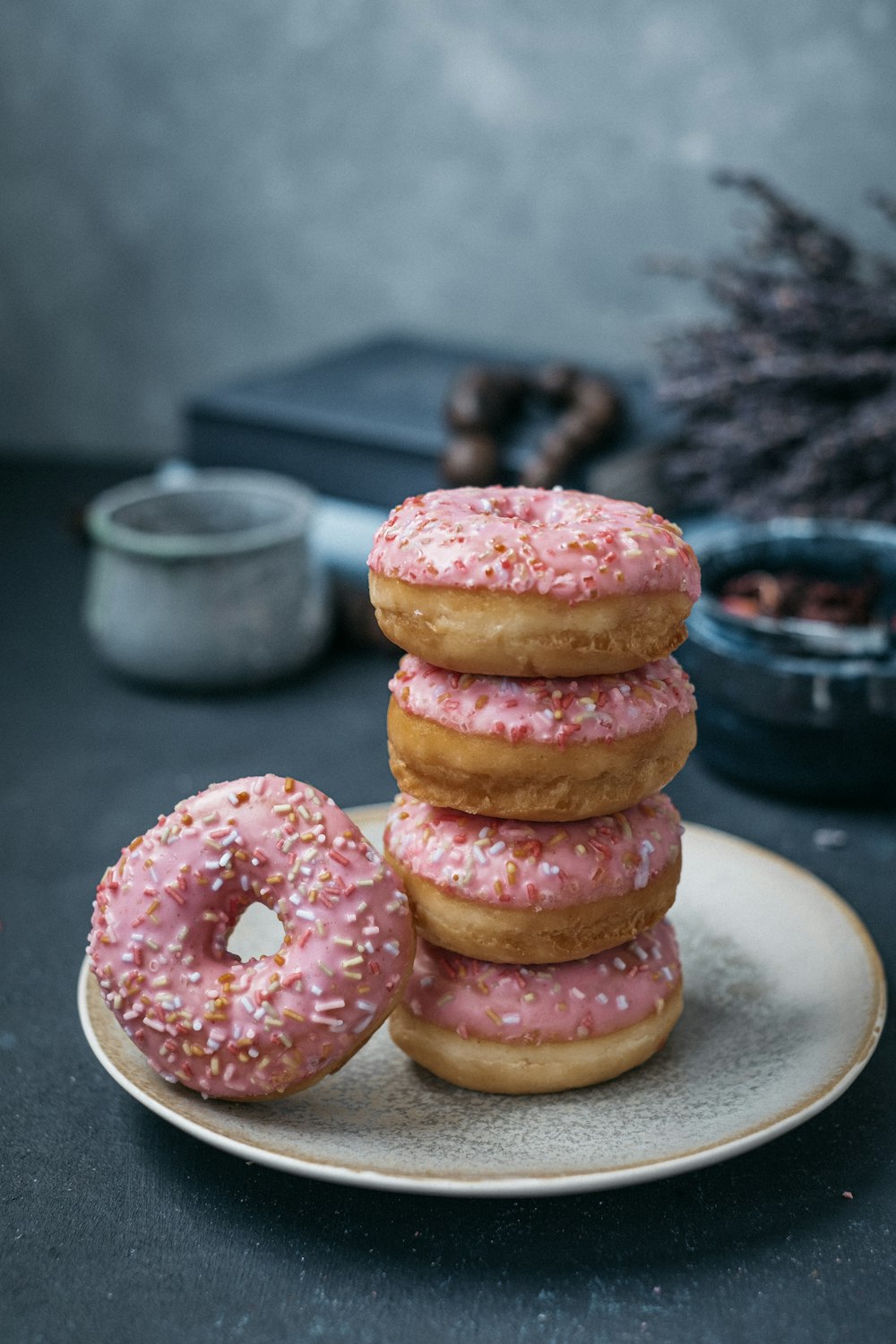 brown and pink donuts on white ceramic plate