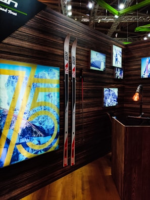 Warm, inviting shop interior with rustic wood walls and ski gear.