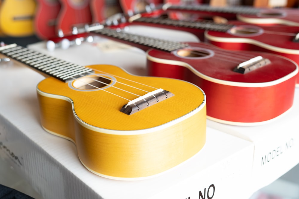 brown acoustic guitar on white table