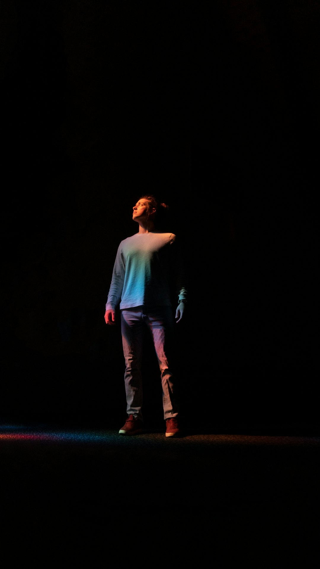 woman in white long sleeve shirt and blue denim jeans standing on stage