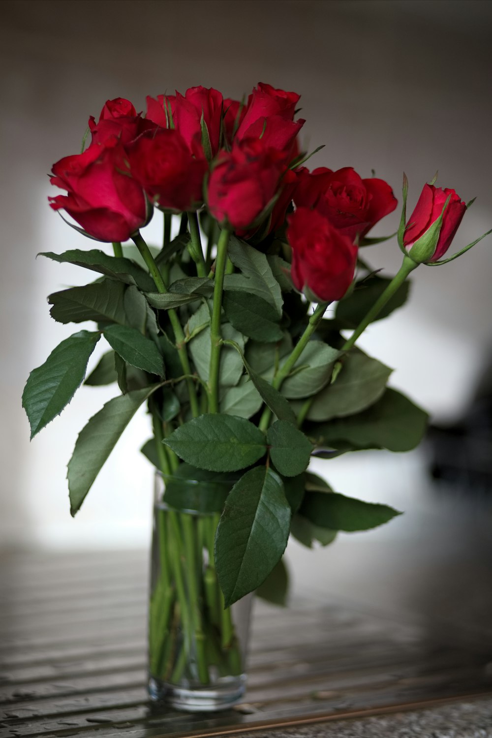 red roses in clear glass vase