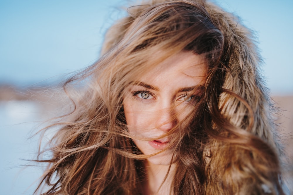 woman with brown hair under blue sky during daytime