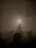 Silhouetted DJ Sos behind the decks with metallic highlights and a sea of hands raised in the dark club.