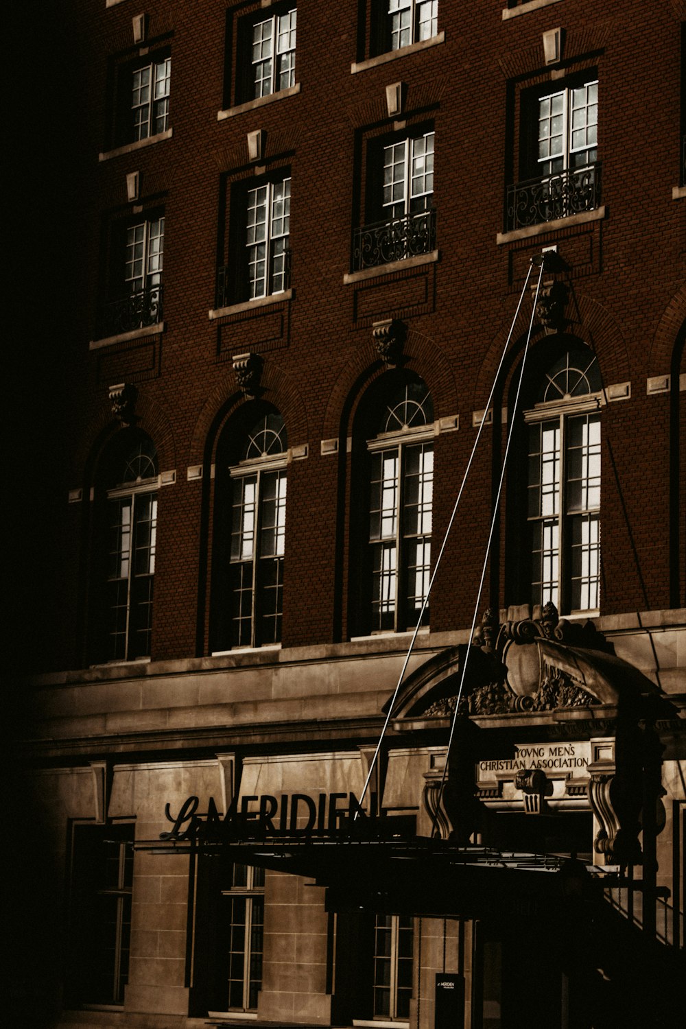 grayscale photo of building with glass window