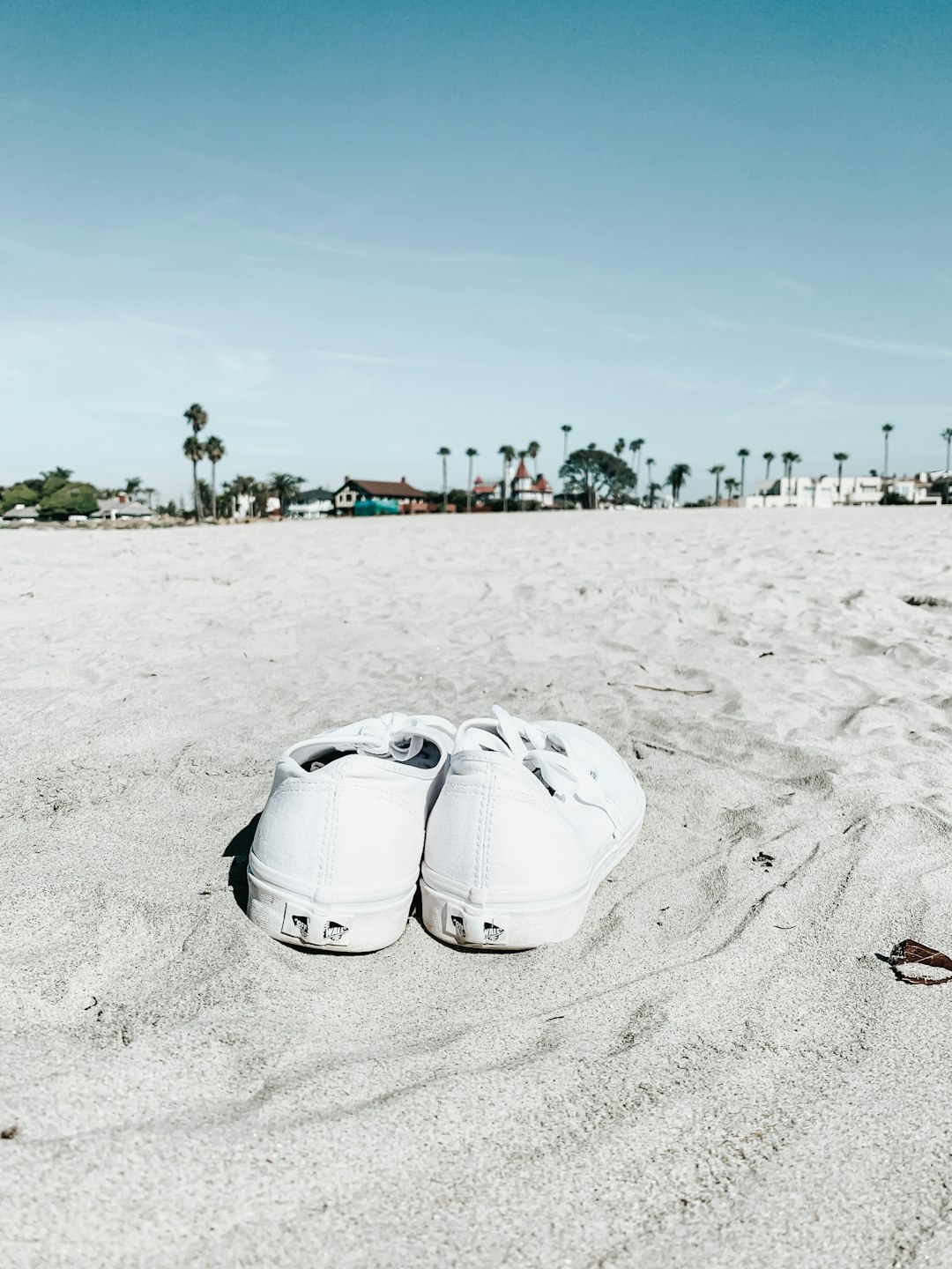 white plastic bucket on white sand during daytime