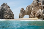 brown rock formation on sea during daytime