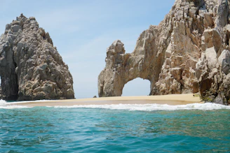 brown rock formation on sea during daytime