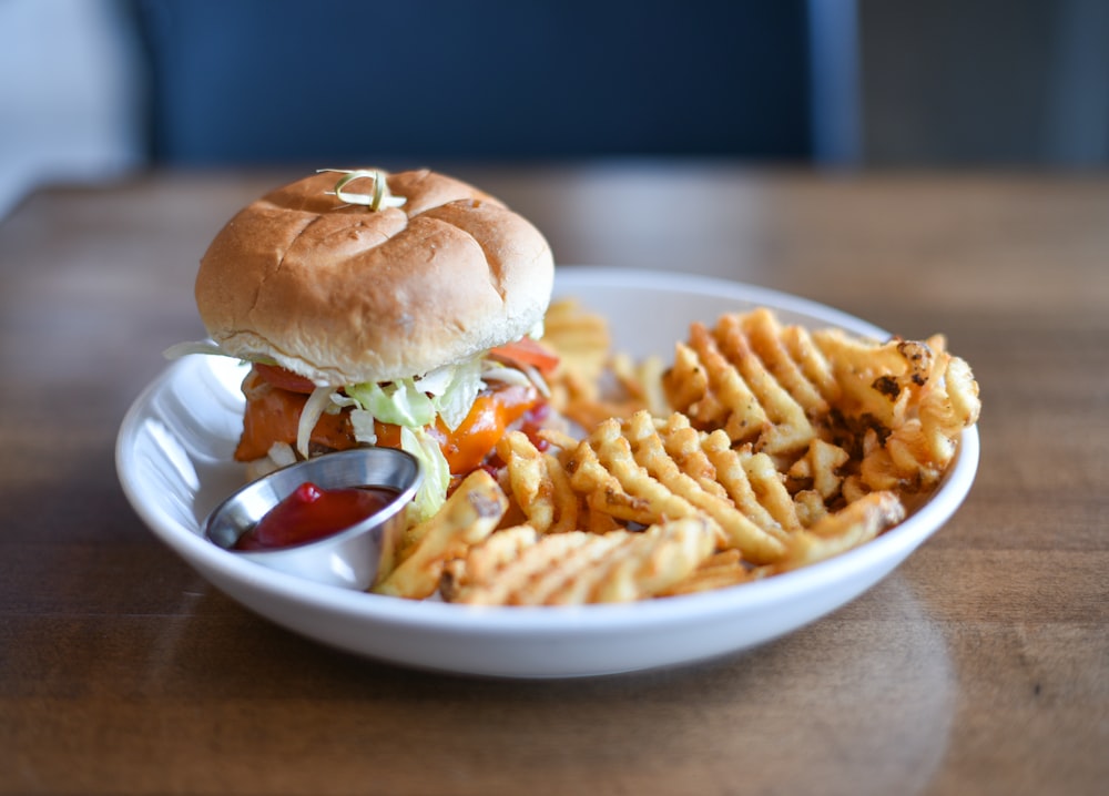 burger and fries on white ceramic plate