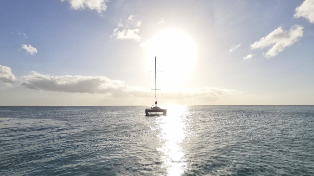 white sail boat on sea during daytime