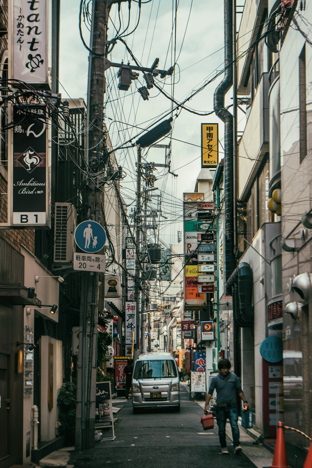 cars on road in between buildings during daytime