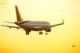 white passenger plane in mid air during daytime