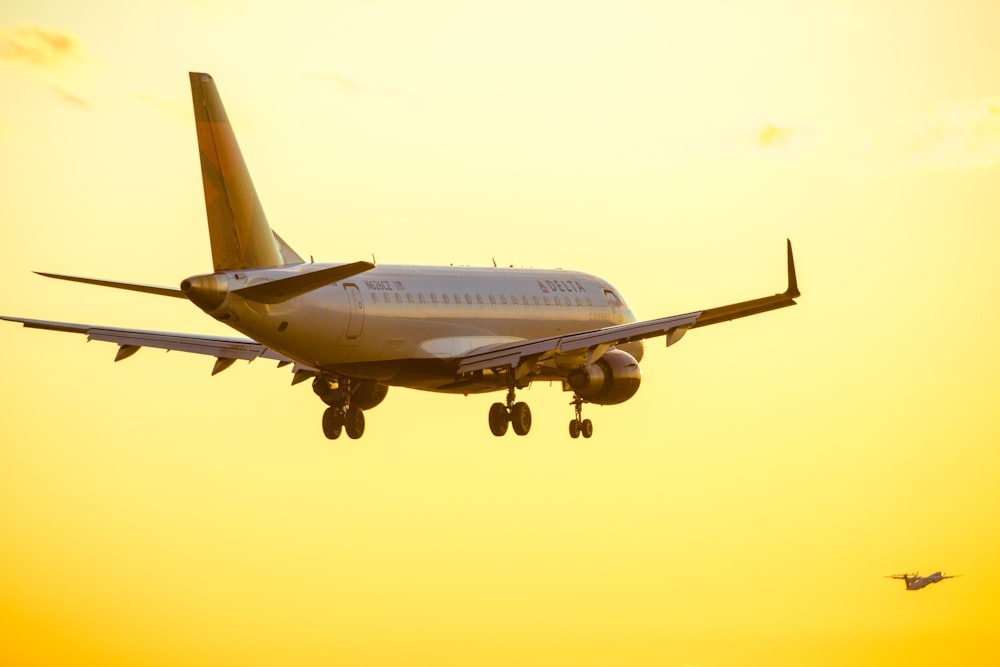 white passenger plane in mid air during daytime