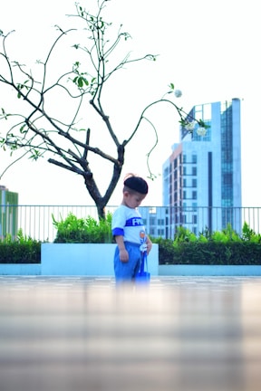 Child playing safely behind a protective net on a terrace.