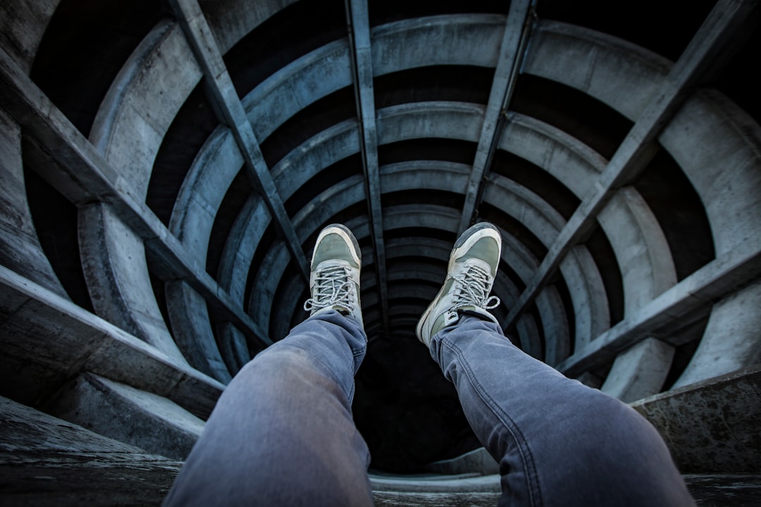 person in blue denim jeans and gray sneakers