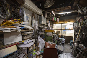 A candid photo of a busy workspace cluttered with tools and projects in progress.