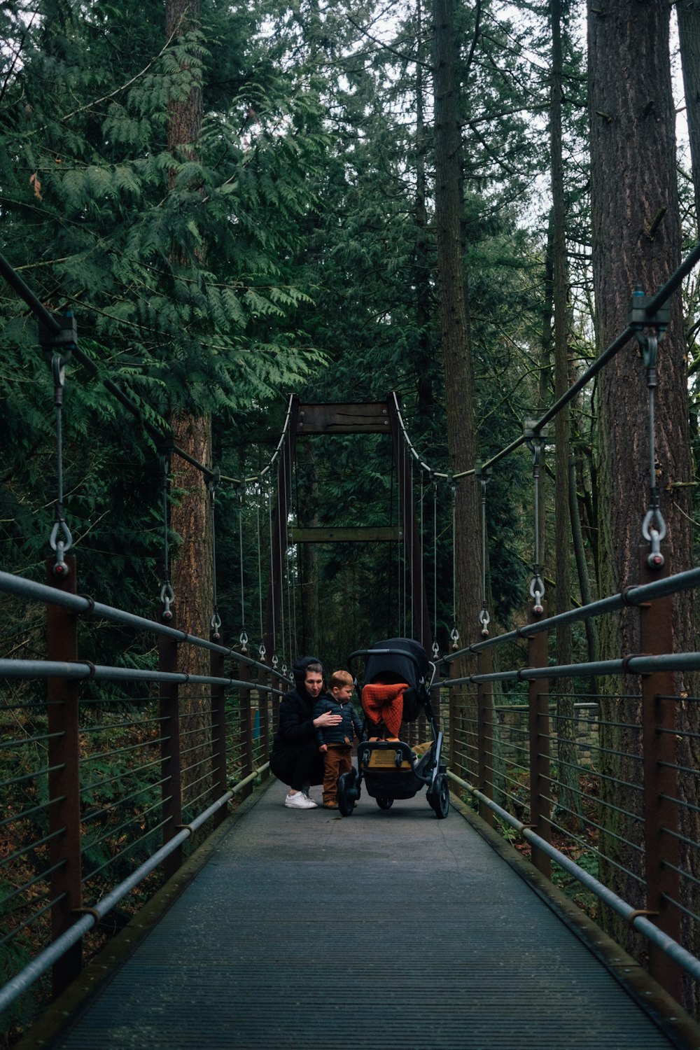 people on hanging bridge during daytime