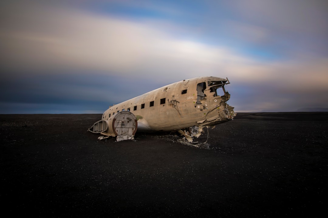 wrecked airplane on gray sand during daytime