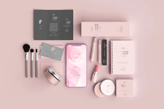 An elegant flat lay of female energy lab branded materials including guides, notebooks, and soft rose accents.
