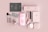 A flat lay of beauty products arranged on a soft pink background.