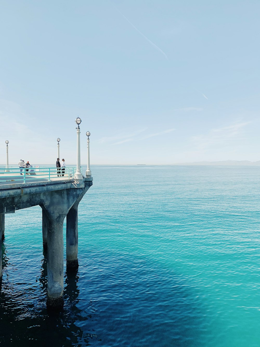 a bridge over a body of water with people on it