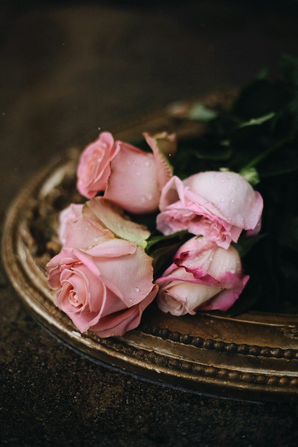 pink roses on brown round plate