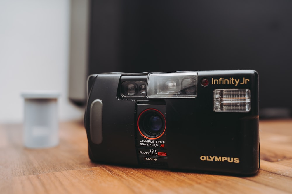 black and silver camera on brown wooden table