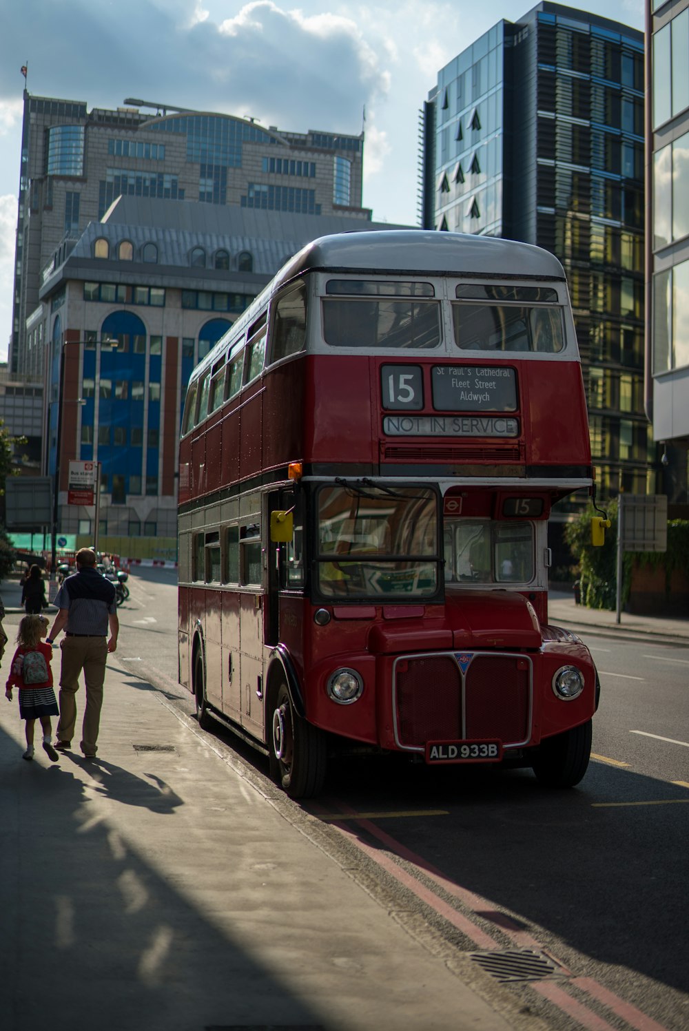 red double decker bus on road during daytime