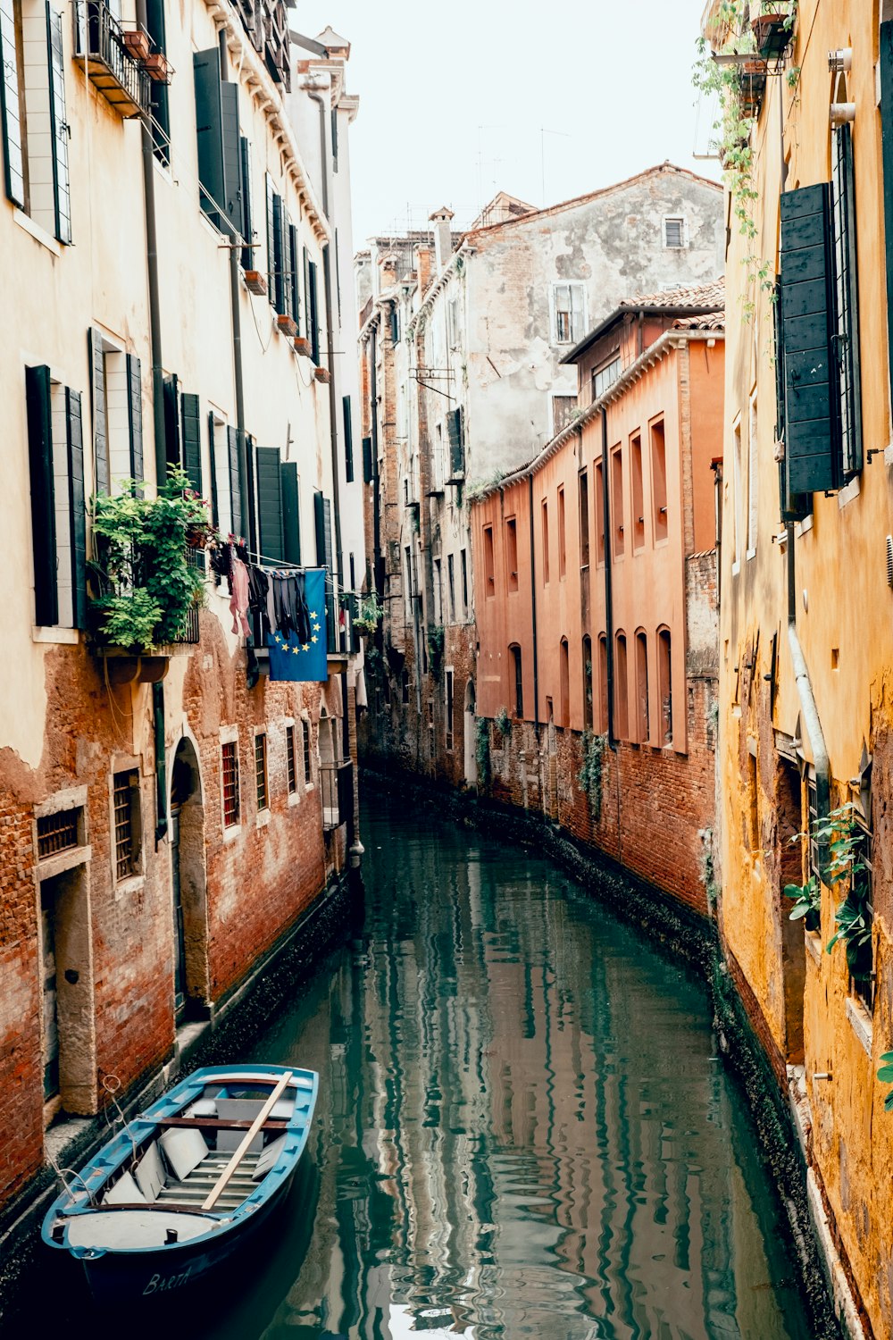 river between brown concrete buildings during daytime