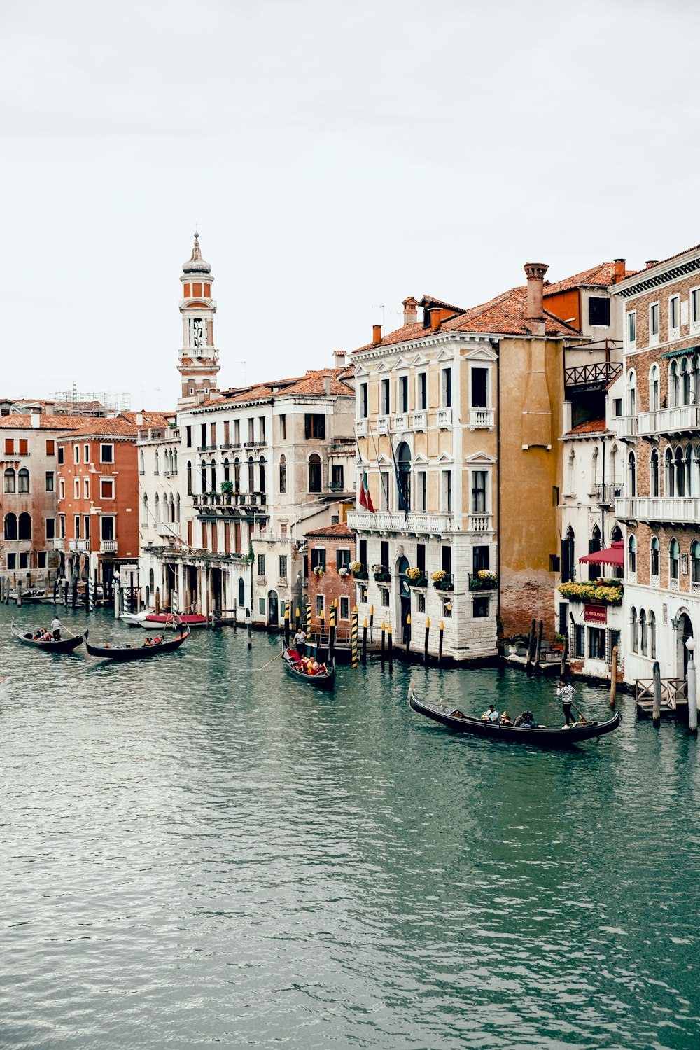 boat on river between buildings during daytime