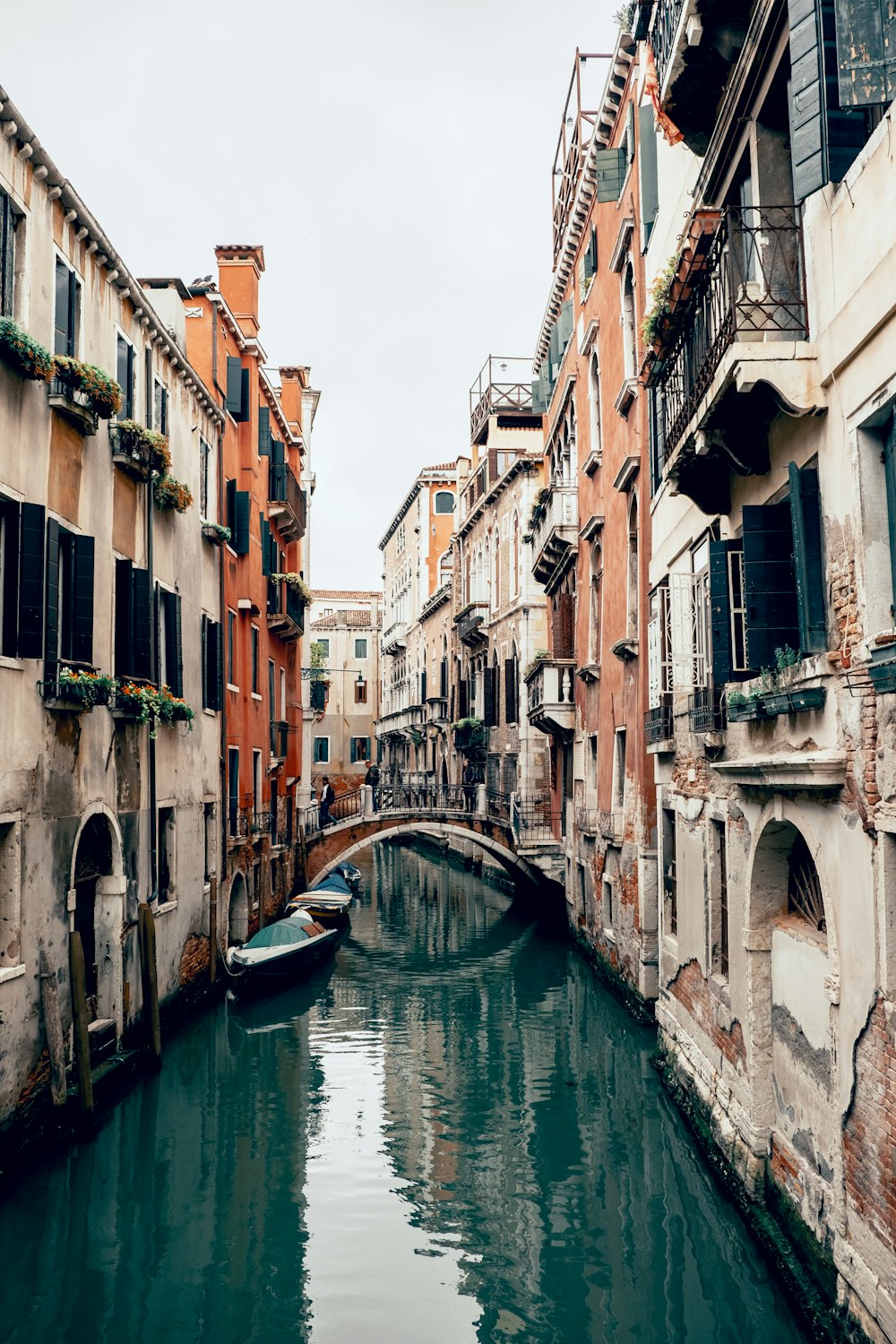 boat on river between buildings during daytime