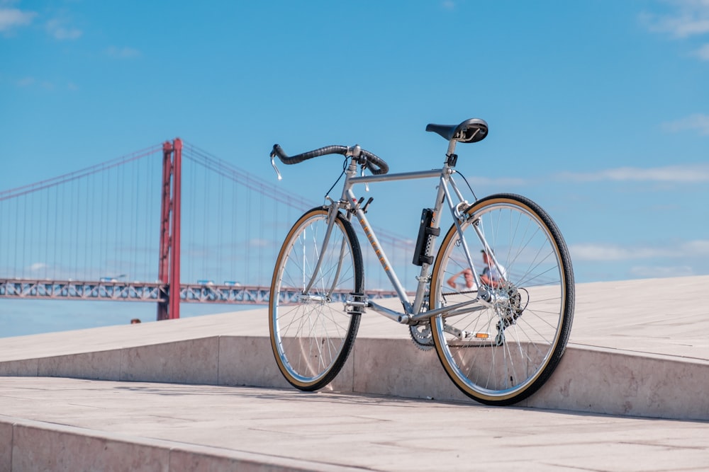 black city bike on bridge during daytime