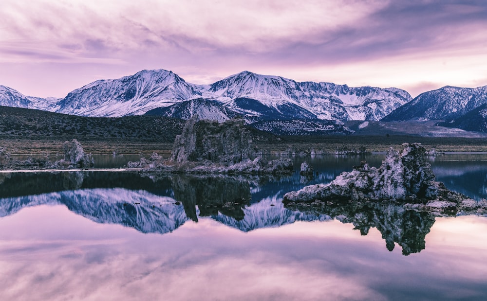 snow covered mountain near lake