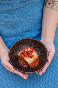 black ceramic bowl on blue textile
