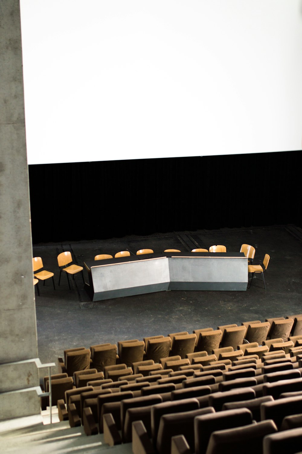 brown wooden chairs on stage