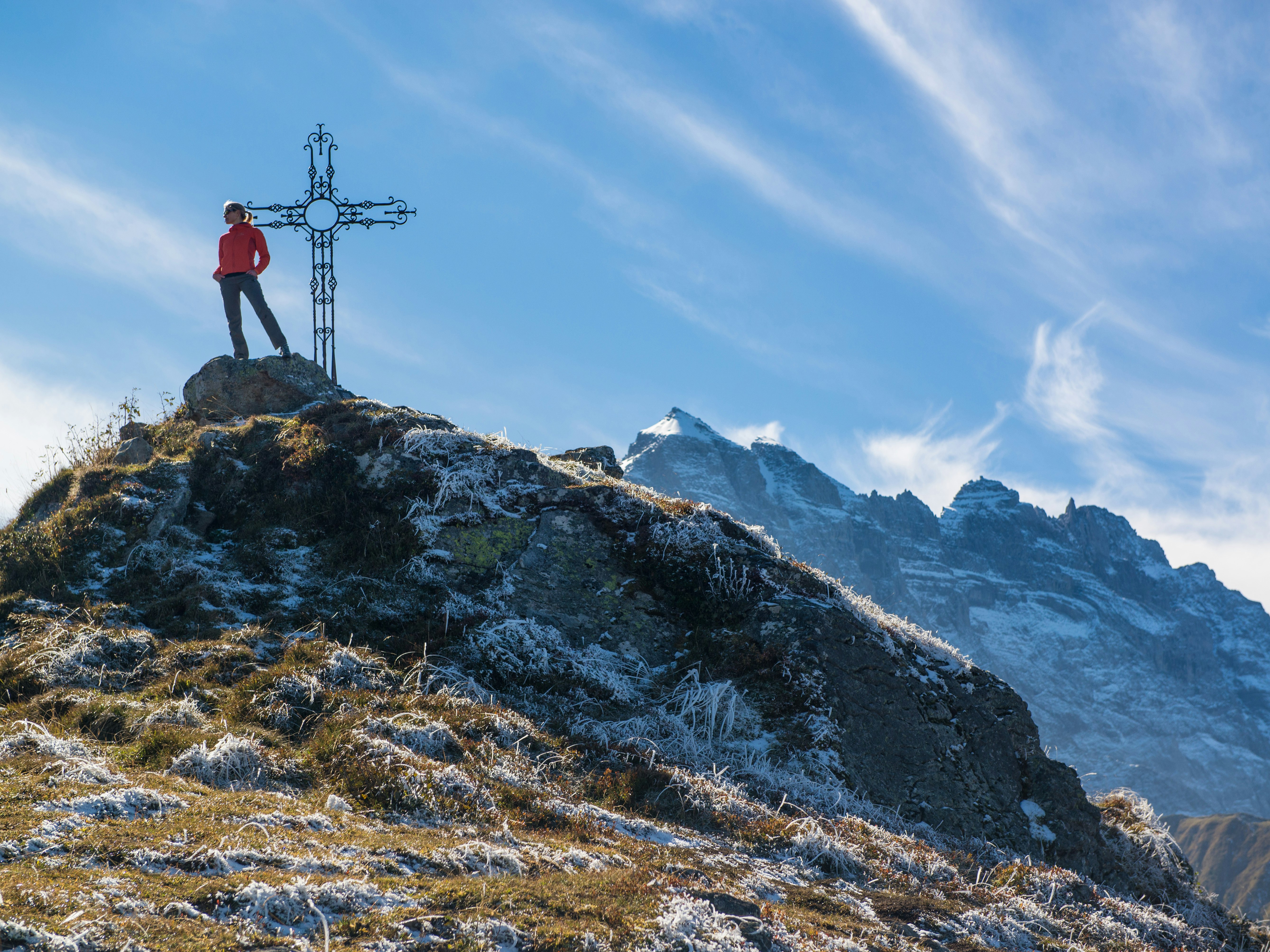 person standing on rock mountain during daytime