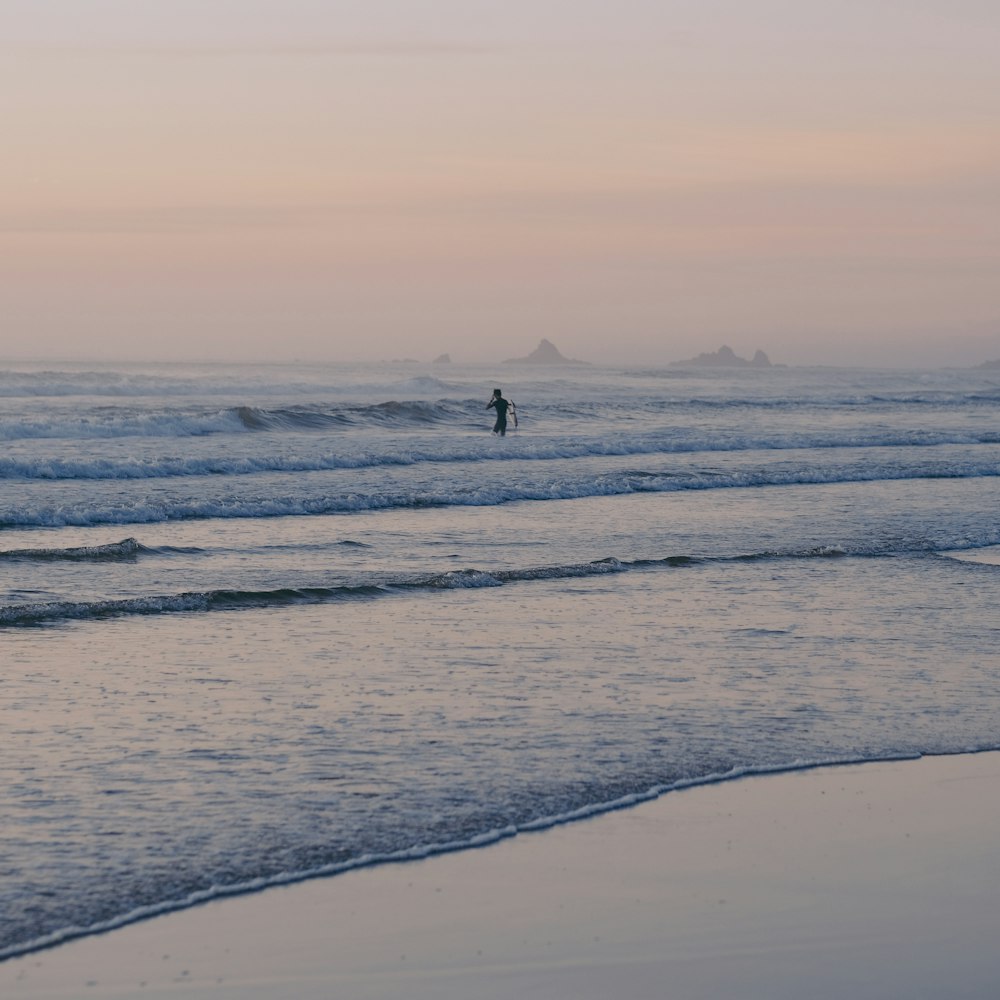 person walking on beach during daytime