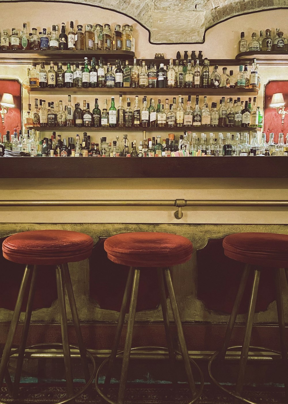 Sgabelli da bar in legno marrone accanto al bancone del bar