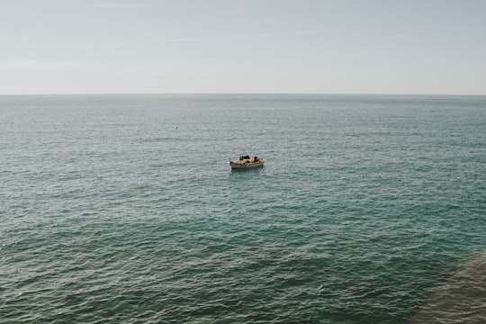 brown boat on sea during daytime in Liguria Italy