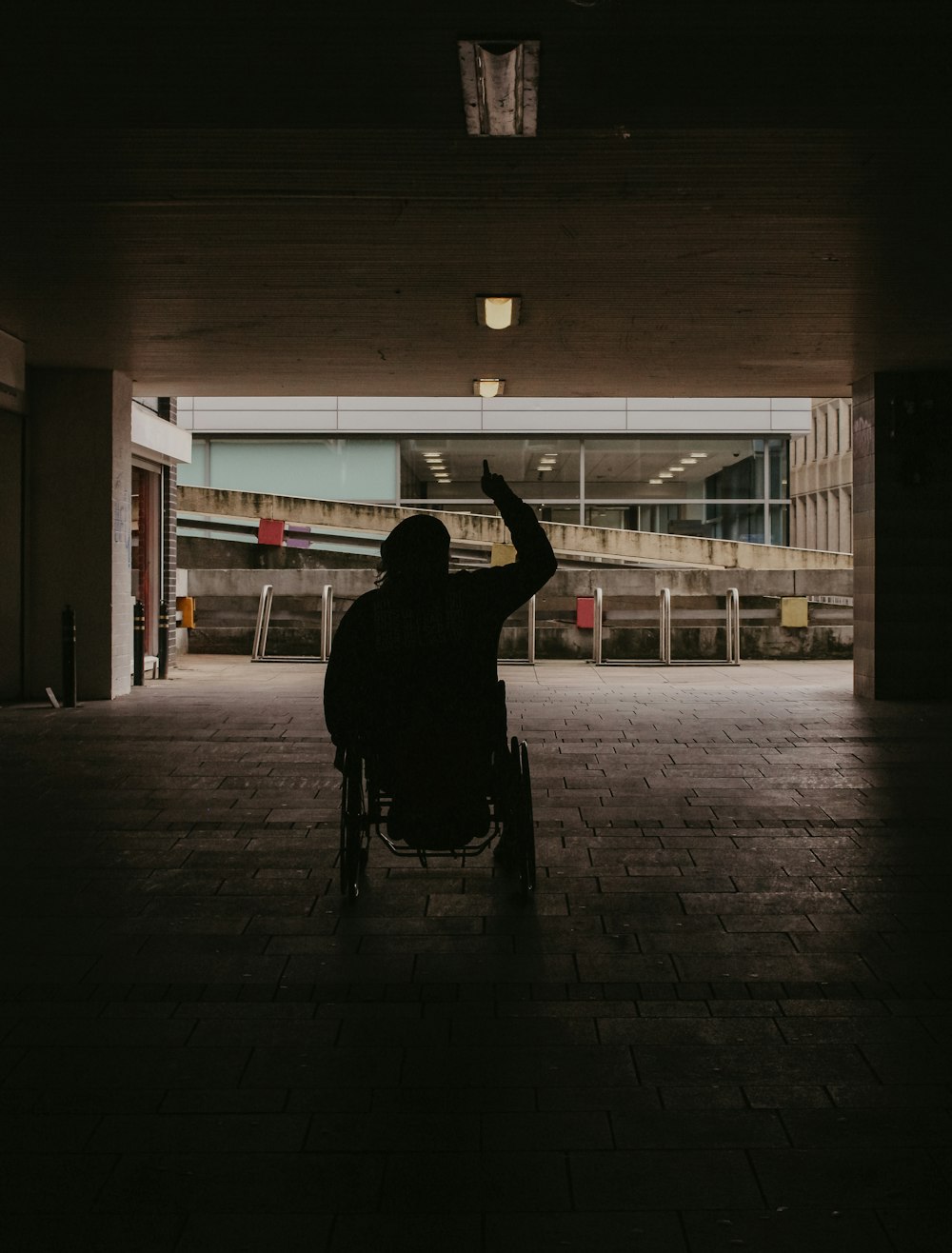 silhouette of person walking on sidewalk during night time