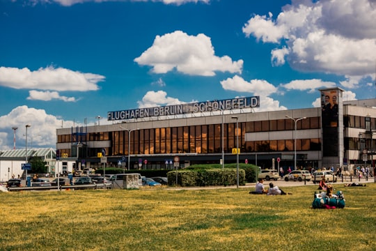 brown and white building under blue sky during daytime in Berlin-Schönefeld International Airport Germany