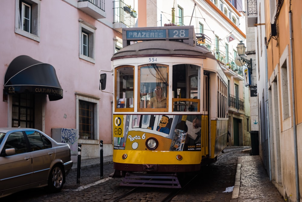 yellow and blue tram on road during daytime